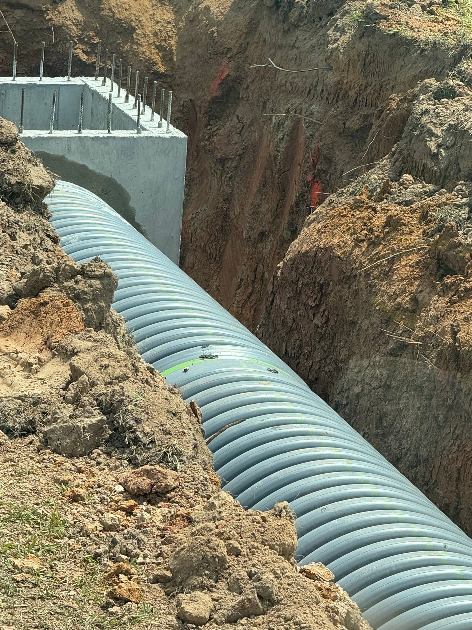 Crew working catch basin CB-06 with pipe connection and tools on site